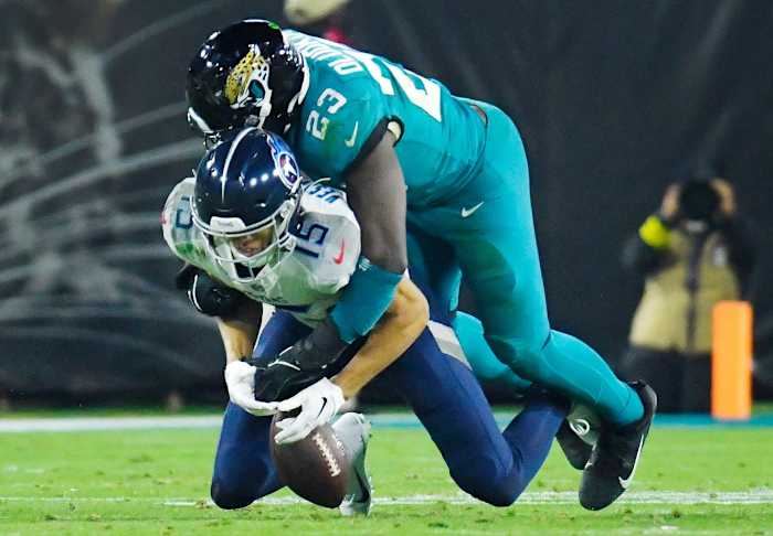 Jacksonville Jaguars linebacker Foyesade Oluokun (23) breaks up a pass play to Tennessee Titans wide receiver Nick Westbrook-Ikhine (15) during third quarter action. The Jacksonville Jaguars hosted the Tennessee Titans to decide the AFC South championship at TIAA Bank Field in Jacksonville, FL, Saturday, January 7, 2023. The Jaguars went into the half trailing 7 to 13 but came back to win with a final score of 20 to 16.